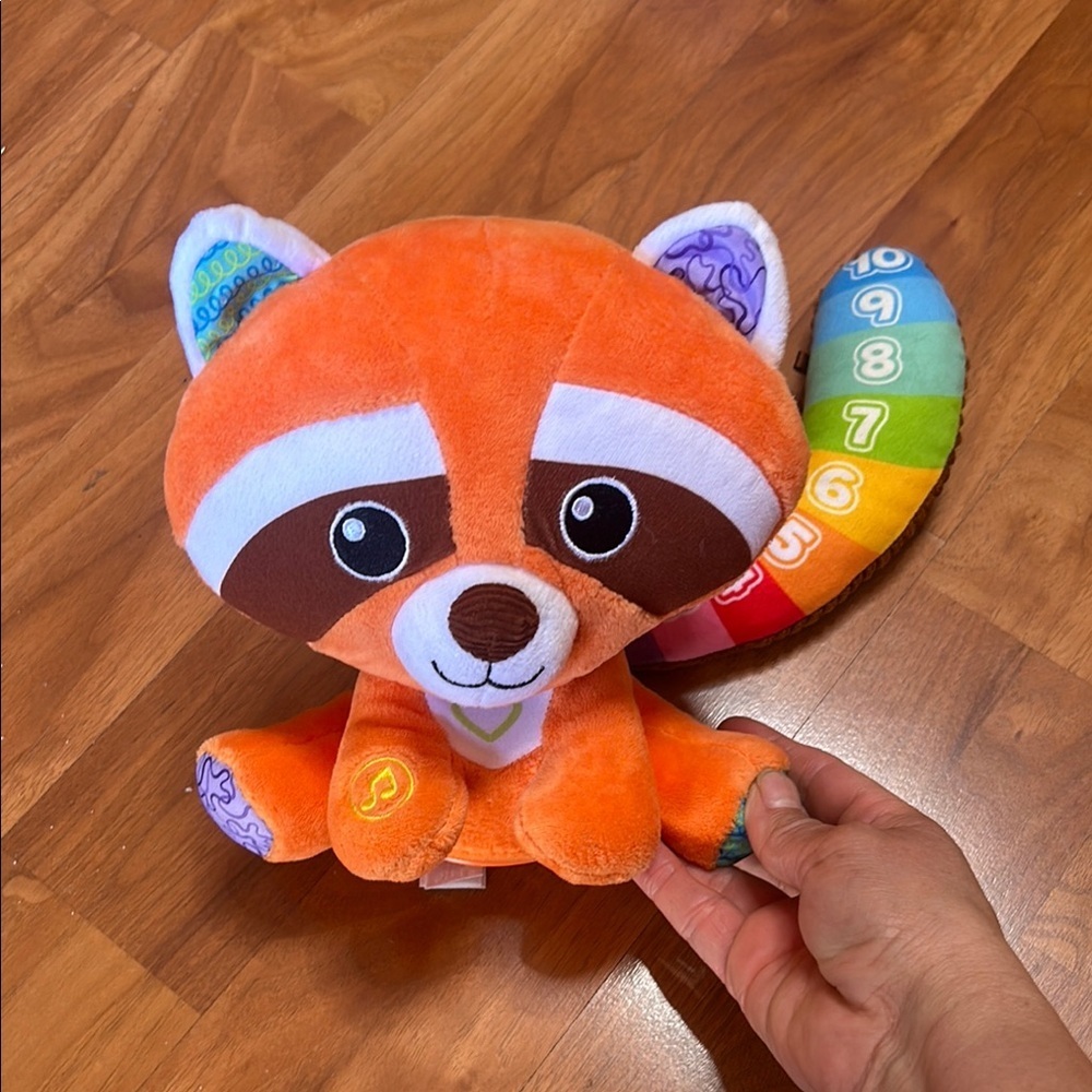 Orange and Blue Stuffed Raccoon Toy with Cartoonish Design